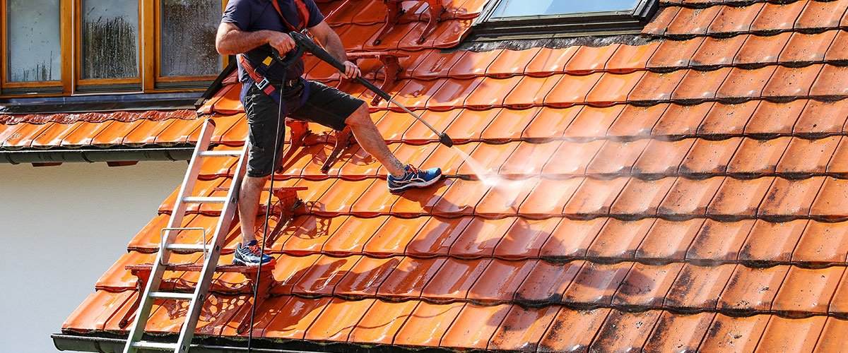 Couvreur réalisant un nettoyage et démoussage de toiture à Entremont-le-Vieux